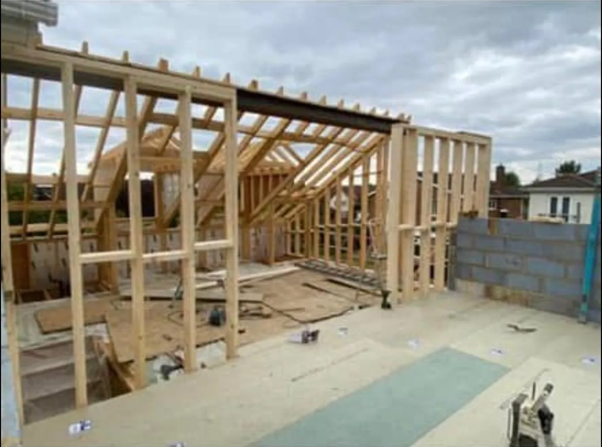 A house being built with wooden framing.